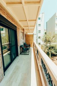 a balcony with a bench on a building at Dreamy Glyfada Apartment in Athens