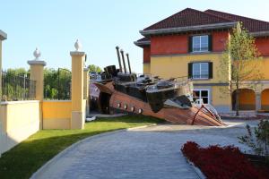 a boat sitting in the yard of a house at Gardaland Adventure Hotel in Castelnuovo del Garda