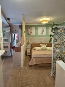 a bedroom with a bed and green walls at Casuzza Nica e Bedda-Centro storico in Palermo