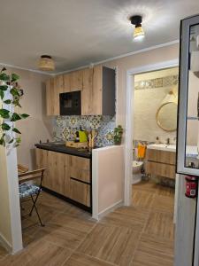 a kitchen with a sink and a bathroom with a tub at Casuzza Nica e Bedda-Centro storico in Palermo +12 photos