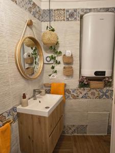 a bathroom with a sink and a mirror at Casuzza Nica e Bedda-Centro storico in Palermo