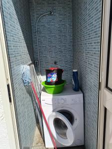 a washing machine in a small bathroom with a washer at La casa delle isole in Torre Chianca +13 photos