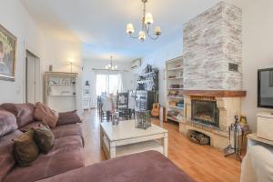 a living room with a couch and a fireplace at Casa Rural Villa montecarmelo in Sanlúcar la Mayor