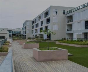 a building with a courtyard with a tree in it at Executive apartment Umhlanga in Durban