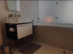 a kitchen with a sink and a bath tub at Executive apartment Umhlanga in Durban +12 photos