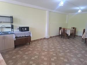 a room with a kitchen and a table and chairs at Elmira B&B in Tatʼev