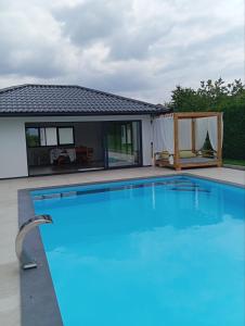 a swimming pool in front of a house at Villa Rustic in Majetići