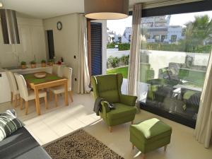 a living room with a table and chairs and a large window at Apartment Orihuela Costa Golf 662 in Los Dolses