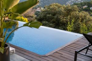 a swimming pool on the deck of a house at Infinity House in Cabrera de Mar