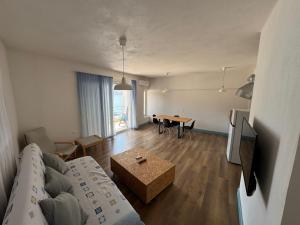 a living room with a couch and a table at Thalassea Apartments in Himare