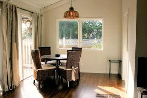 a dining room with a table and chairs and a window at Elegant Carmel Cottage in Carmel