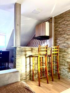 a kitchen with a table and chairs in a room at Apartmani Radovanovic in Soko Banja +4 photos