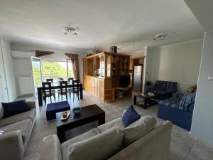 a living room with a couch and a table at Neraida view in Neráïdha