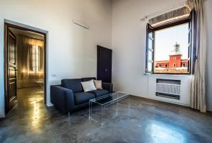 a living room with a blue couch and a window at Faro Capo Spartivento in Chia