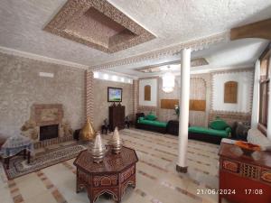 a living room with a couch and a fireplace at Maison d'hotes in Tangier