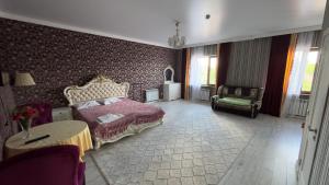 Postel nebo postele na pokoji v ubytování Гостевой дом Мерей + 5 fotografií