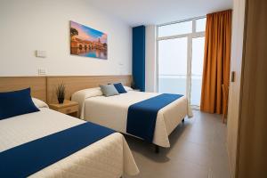 Postel nebo postele na pokoji v ubytování Hotel Aldebaran