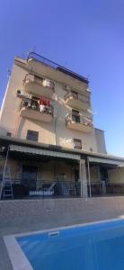 a building with a swimming pool in front of it at House Calamigna in Ventimiglia di Sicilia