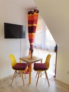 a dining room with a table and two chairs at Mont Melis in Sînpetru