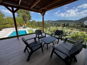 a patio with chairs and a table and a pool at Villa Relax24 - Luxury Villa in Val de Pop in Alcalalí +14 photos