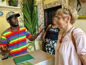 two men and a woman standing next to a table at Mount Zion Guest House, Mtwapa Mtomondoni in Mombasa