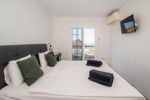 a bedroom with a white bed with two pillows on it at Villa Zion Tenerife in Adeje +55 photos