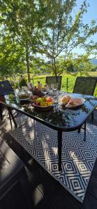 a table with food on it on a patio at Urocze Apartamenty in Cięcina