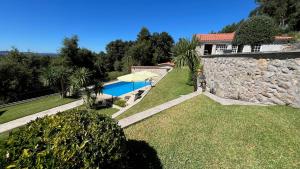an external view of a house with a swimming pool at Casa do Cabo Alto in Areal