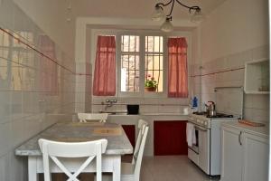 a kitchen with a table and chairs and a sink at La Rue in Tortoreto Lido