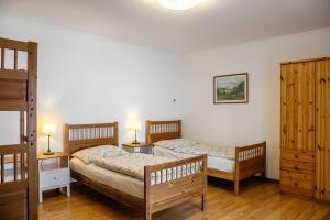 A bed or beds in a room at Sváb Ház