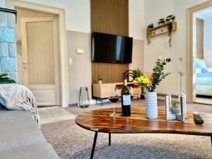 a living room with a table with two glasses of wine at Belvedere Apartment - Riverside - Zentrum - Netflix - Liliensteinblick in Königstein an der Elbe