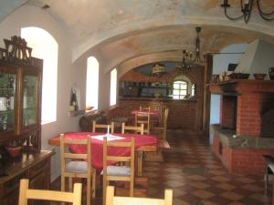 a dining room with a table and a fireplace at Penzion Paták in Kamýk nad Vltavou