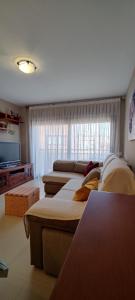 a living room with several couches and a flat screen tv at Ca l'Esmolet in Tremp +17 photos