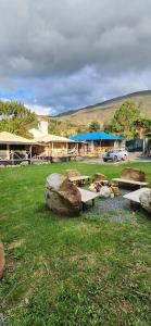 a group of rocks and benches in front of a building at Glamping Villa de Leyva in Estación El Salto