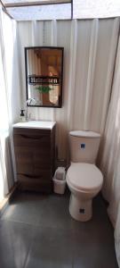 a bathroom with a white toilet and a sink at Glamping Villa de Leyva in Estación El Salto