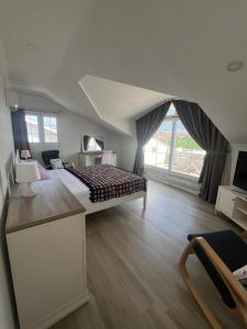 a bedroom with a bed and a large window at YeldA in Fethiye
