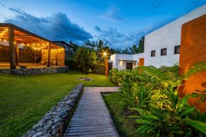 una casa con una pasarela de madera en un patio en Salento Pequeño Hotel, en Salento