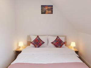a bedroom with a white bed with two lamps at Mont Melis in Sînpetru