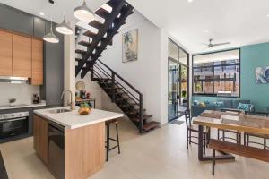a kitchen and dining room with a spiral staircase at Chic Bohemian Villa with a Private Swimming Pool and Stunning Outdoor Space in Coco