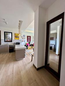 a kitchen and living room with a large mirror at Happy Place Apartment in Gatunga