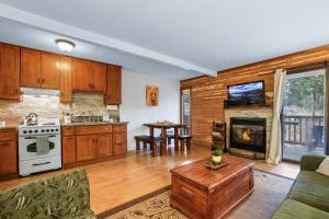 a kitchen with a living room with a fireplace at Alpine Alcove: Tahoe Tranquility Near Kings Beach in Tahoe Vista