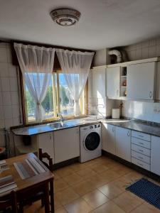 a kitchen with a sink and a washing machine at Concepción Arenal 175 in Marín