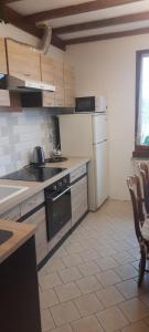 a kitchen with a stove and a white refrigerator at Maison village de Bigorre in Ossun +26 photos