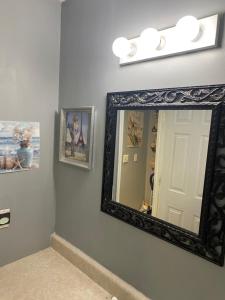 Un espejo en la pared del baño con una luz. en Paul&Karen, en Nashville