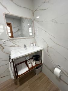 a white bathroom with a sink and a mirror at Teror Centro 3 in Teror +12 photos