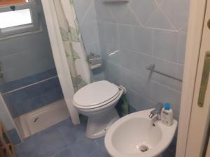 a small bathroom with a toilet and a sink at Da Massimo in Cefalù +7 photos