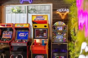 a group of arcade games in front of a building at Family Paradise Playhouse includes Pool and Gameroom in Dallas