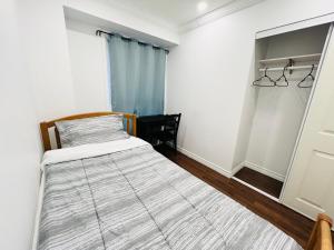 a small bedroom with a bed and a window at ComfyRoom in Toronto