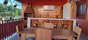 a wooden table and chairs on a patio at POUSADA DOS REIS in Salinópolis