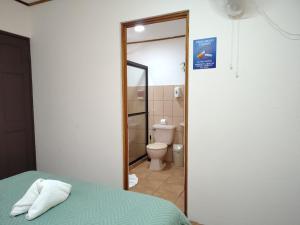 a room with a bed and a bathroom with a toilet at Hotel Santa Fe B&B in Monteverde Costa Rica +115 photos